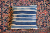 Handwoven striped indigo pillow, featuring varied blue and ivory with unique character.