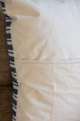 Indigo pillow's heavy canvas back, showing envelope enclosure and unique black white stitch.
