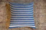 Finely woven indigo blue and off-white striped pillow textile.