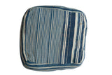 Vintage indigo striped floor pillow showcasing handwoven texture and varied dye.