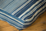 Vintage indigo floor pillow corner detail, showing handwoven blue and cream stripes.