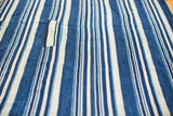 Hand woven vintage indigo blue striped textile with stitched detailing and natural texture.