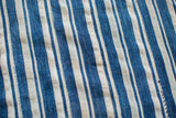 Textural details of the hand-woven indigo blue and light striped collectible textile.