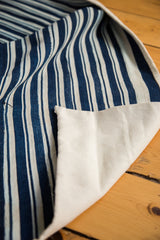 Vintage indigo blue striped African hand-woven textile runner, showing canvas backing.