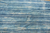 Varied indigo blue stripes with intricate hand-woven texture on vintage African cotton textile.
