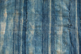 Collectible vintage indigo textile close-up, featuring hand-woven strips and rich blue variations.