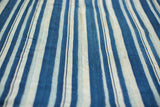 Textured detail of vintage hand-woven indigo and light striped cotton.