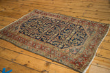 Distressed navy ground with intricate Herati pattern on this vintage Heriz rug.