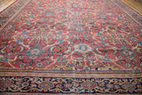 Distressed rusty orange antique Mahal carpet, revealing allover pattern, worn texture, and navy border.