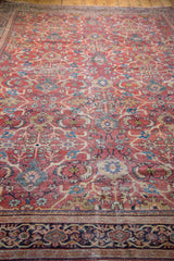 Distressed antique Mahal carpet pile, rusty orange field with allover curvilinear motifs.