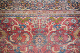 Antique Mahal rug: distressed rusty orange field, blue-green curvilinear motifs, and patterned border detail.