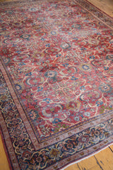 Distressed rust orange antique Mahal carpet, allover floral motifs, and blue borders.
