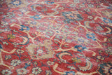 Distressed antique Mahal carpet with exposed knot heads on its rusty orange field.