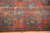 Distressed deep burgundy field and sky blue geometric palmette motifs on an antique Mehrevan fragment.