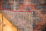 Antique Mehrevan rug folded edge with tight foundation weave and distressed burgundy, blue pile.