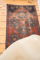 Distressed burgundy field with sky blue geometric palmettes on an antique Mehrevan rug.