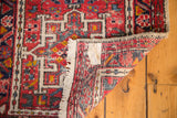 Vintage Karaja rug corner with fringe, geometric pattern, and hand-knotted foundation.