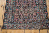 Vintage Kurdish rug end, repeating muted pink and blue boteh, geometric border.