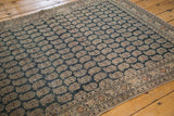 Antique Persian Haji Jalili Tabriz features repeating boteh design on dusty charcoal field with visible wear.