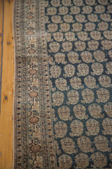 Antique Tabriz rug detail: intricate floral border, charcoal field, repeating boteh, and patina.