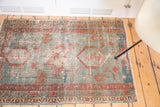 Time-softened pile of a late 19th century Serapi rug with blue field and terra cotta motifs.