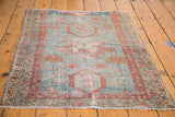 Antique Serapi rug lower corner, powder blue field, pale terra cotta geometric patterns, aged fringe.