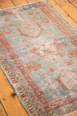 Antique Persian Serapi rug fragment with time-softened powder blue, terra cotta, and low pile.