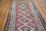 Late 19th century Kurdish Bijar runner with distressed geometric Caucasian pattern in blue and red.