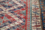 Antique Bijar runner with detailed geometric Caucasian motifs in red, blue, and cream.