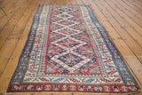 Corner of antique Bijar runner, red, navy, ivory geometric Caucasian pattern.