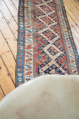 Geometric Caucasian design and time-softened patina of an antique Bijar rug runner.