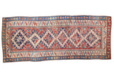 Antique Kurdish Bijar runner featuring distressed red, blue, and cream geometric diamond patterns, 3'3