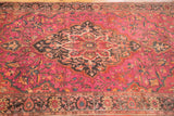 Finely knotted vintage Farahan Sarouk rug, charcoal medallion on ruby magenta floral field.