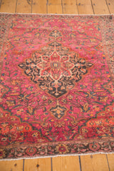 Vintage Farahan Sarouk rug's ruby magenta, orange, charcoal floral patterns with fringe.