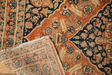 The hand-knotted back and secured fringe on the corner of an antique Tabriz rug.
