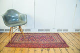 Antique Turkmen rug's softened cranberry red and blue tones, intricate sextuplet medallions.