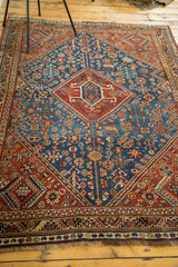 Geometric serrated medallion in madder root rust, vivid sky blue field with tribal motifs.