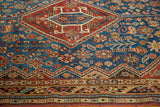Antique Shiraz rug with vivid sky blue field, serrated maroon medallion, and detailed borders.
