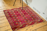 Intricate Bokhara geometric patterns and vibrant magenta field of an early 20th century Turkmen rug.