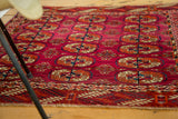 Close view of vintage Bokhara design Turkmen rug, showing fine weave, magenta, rust, navy patterns.