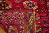Magenta, rust, and navy geometric Bokhara design pile with intricate reverse weave.