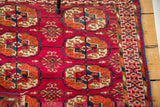 Fine weave displaying intricate geometric patterns in magenta, rust, and navy.