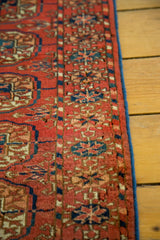 Antique Turkmen rug with geometric elephant footprint motif and renewed blue selvage.