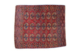 Antique Turkmen square rug with repeating elephant footprint design in oxidized cranberry red, teal blue.