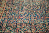 Antique Fereghan rug: intricate indigo, madder red, saffron geometric and floral design, storied wear.