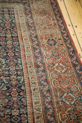 Antique Fereghan rug detail with distressed madder red and indigo blue geometric patterns.