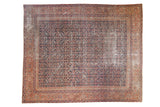 Antique Fereghan carpet, time-softened indigo field, ornate madder red borders, circa 1900.