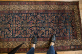 Antique Hamadan rug detail with indigo blue Herati field, woven birds, plum, and Serbend border.