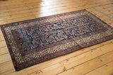 Antique Hamadan rug corner, showcasing the meandering vine Serbend border and indigo Herati field.