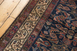 Intricate indigo Herati field with woven birds, detailed antique ivory Serbend border.